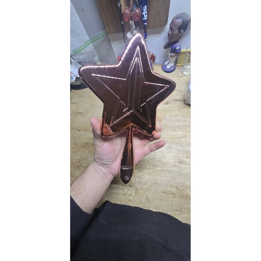 Jeffree Star Cosmetics Rose Gold Chrome Star Hand Mirror.